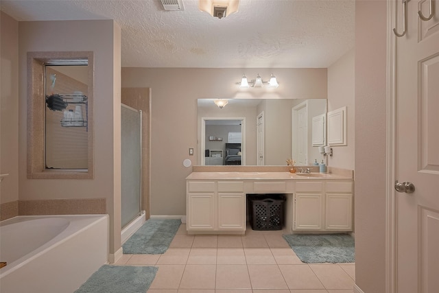 21415 Park Timbers Ln, Katy, TX 77450 - bathroom with a stall shower, tile patterned flooring, vanity, a garden tub, and a textured ceiling