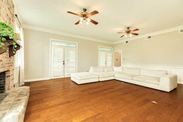 3003 Sky Ranch Dr, Alvin, TX 77511 - unfurnished living room featuring a ceiling fan, a brick fireplace, dark wood-style flooring, and ornamental molding