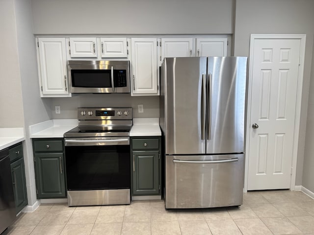 2011 Spenwick Dr Unit 513, Houston, TX 77055 - kitchen with stainless steel appliances, light countertops, light tile patterned floors, and white cabinetry