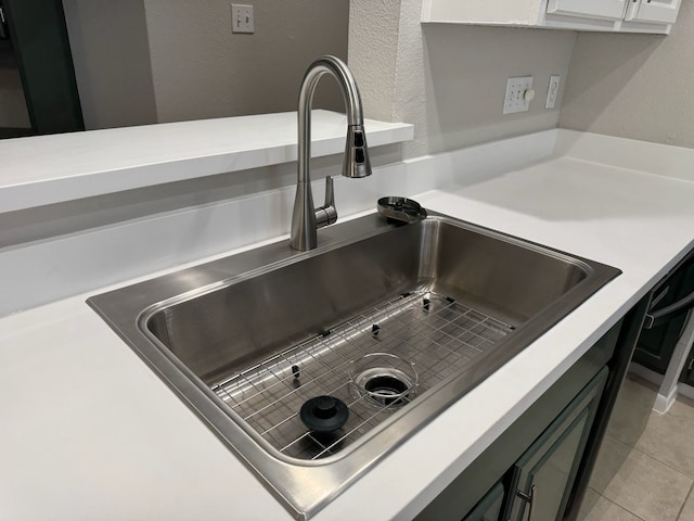 2011 Spenwick Dr Unit 513, Houston, TX 77055 - kitchen view of a sink, light countertops, a textured wall, and white cabinets