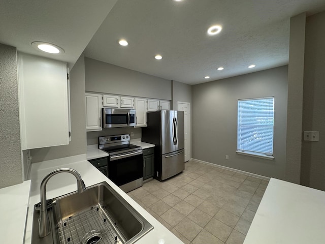 2011 Spenwick Dr Unit 513, Houston, TX 77055 - kitchen with stainless steel appliances, a sink, recessed lighting, light countertops, and white cabinets
