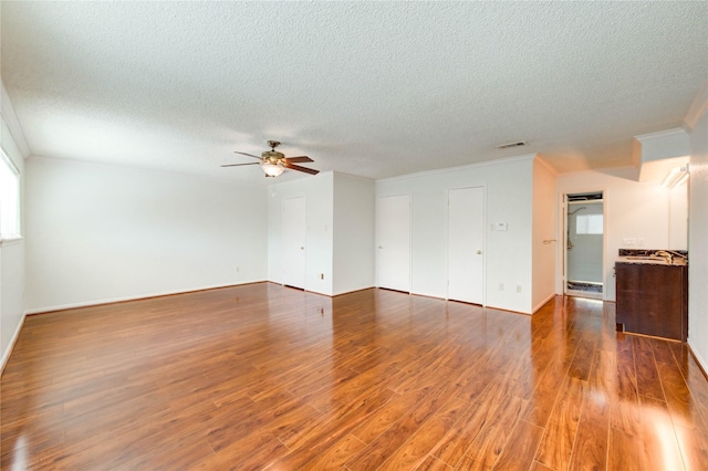 14171 Misty Meadow Ln, Houston, TX 77079 - unfurnished living room featuring a textured ceiling, wood finished floors, ceiling fan, crown molding, and baseboards