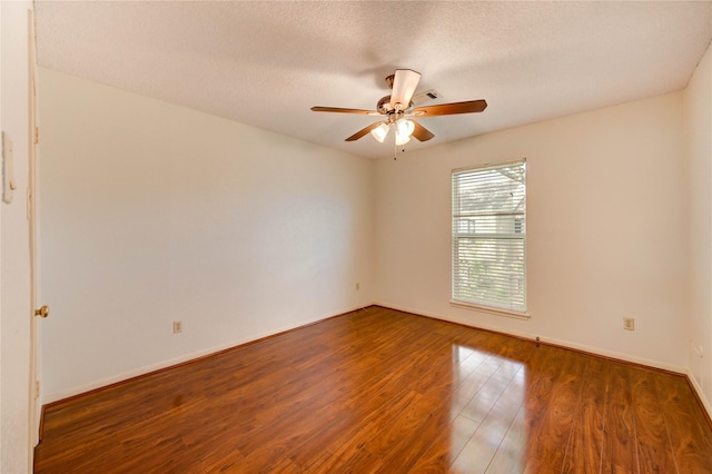 14171 Misty Meadow Ln, Houston, TX 77079 - unfurnished room with wood finished floors, ceiling fan, baseboards, and a textured ceiling