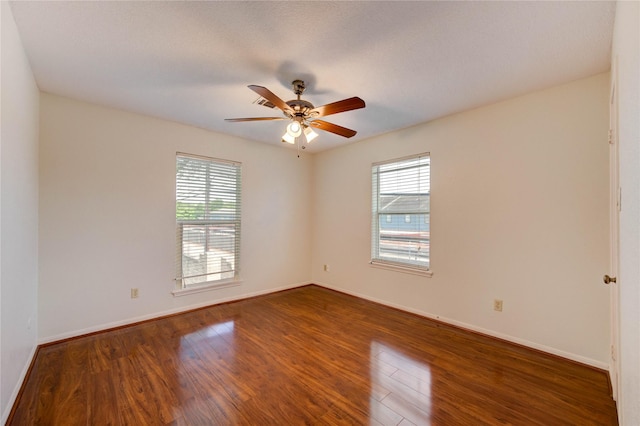 14171 Misty Meadow Ln, Houston, TX 77079 - unfurnished room with healthy amount of natural light, wood finished floors, a ceiling fan, and baseboards