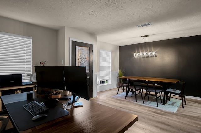 12250 Beamer Rd, Houston, TX 77089 - dining space featuring a textured ceiling, wood finished floors, a chandelier, and a desk