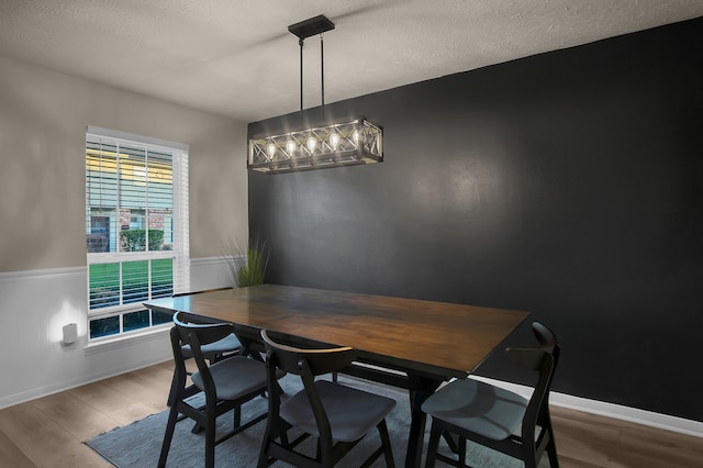 12250 Beamer Rd, Houston, TX 77089 - dining area featuring wood finished floors, baseboards, and a textured ceiling