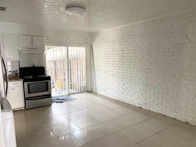 7449 Cook Rd, Houston, TX 77072 - kitchen with stainless steel electric range oven, brick wall, white cabinetry, under cabinet range hood, and a textured ceiling