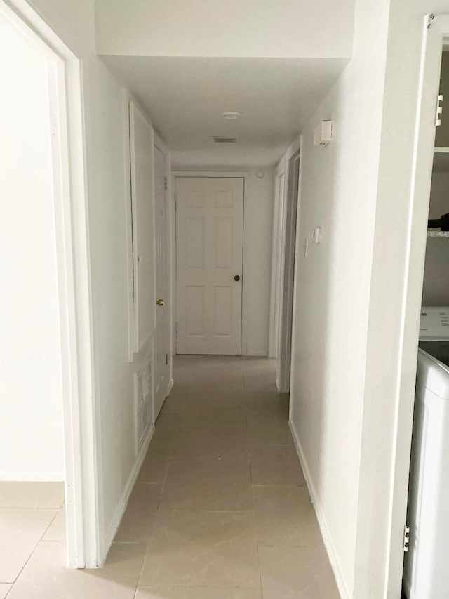 7449 Cook Rd, Houston, TX 77072 - corridor featuring light tile patterned floors and baseboards