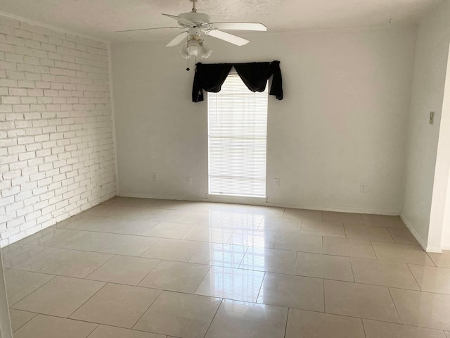 7449 Cook Rd, Houston, TX 77072 - unfurnished room featuring ceiling fan, light tile patterned floors, brick wall, and baseboards