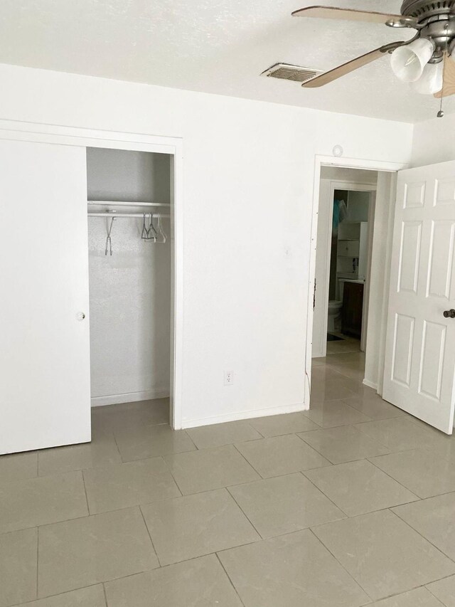7449 Cook Rd, Houston, TX 77072 - unfurnished bedroom with tile patterned floors, a closet, a ceiling fan, and baseboards