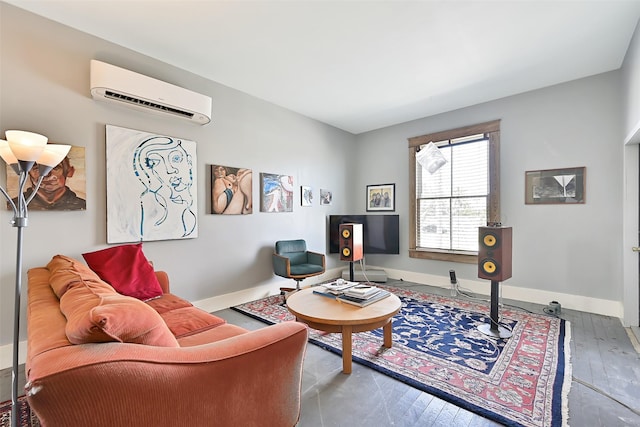 2215 30th St, Galveston, TX 77550 - living room featuring an AC wall unit, baseboards, and hardwood / wood-style floors