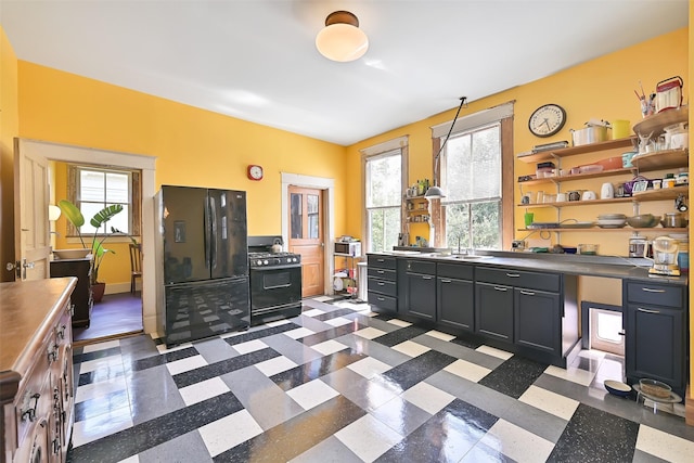 2215 30th St, Galveston, TX 77550 - kitchen with black appliances, healthy amount of natural light, open shelves, and dark cabinetry
