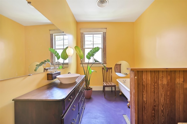 2215 30th St, Galveston, TX 77550 - full bath with a freestanding tub, vanity, and baseboards
