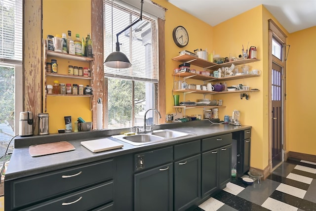 2215 30th St, Galveston, TX 77550 - kitchen with a sink, open shelves, dark floors, baseboards, and dark countertops