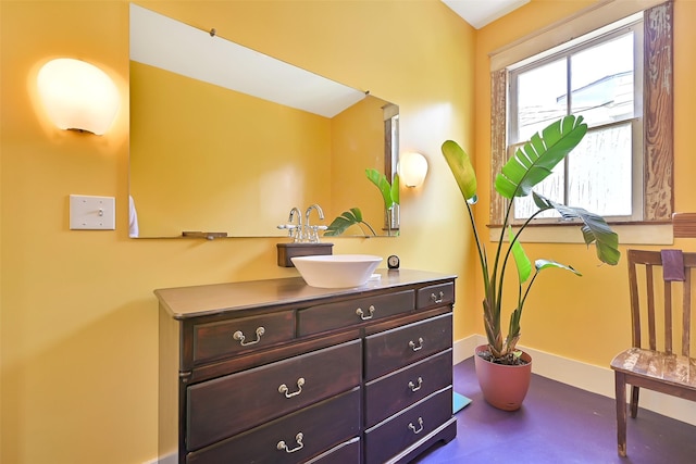2215 30th St, Galveston, TX 77550 - bathroom with vanity, baseboards, and finished concrete flooring