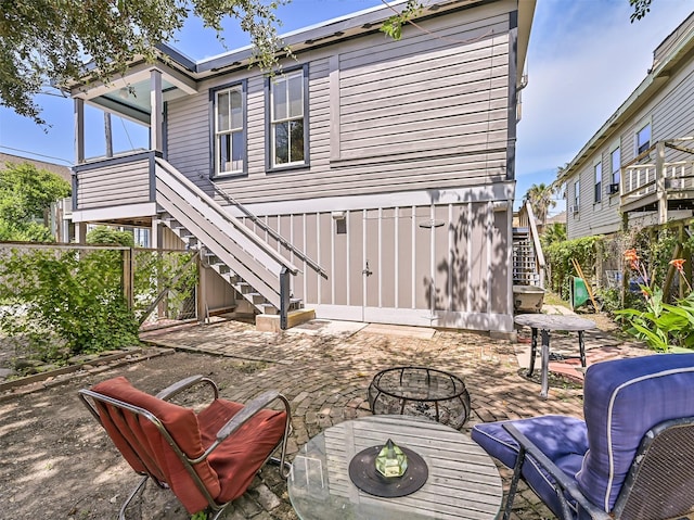 2215 30th St, Galveston, TX 77550 - back of house with stairway, a patio area, and a fire pit