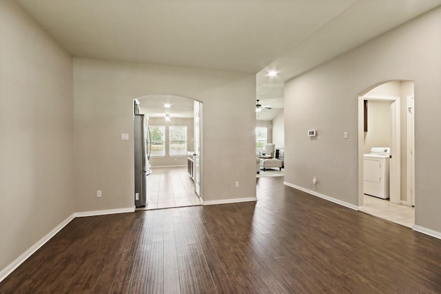 9115 E Lakeside Dr, Magnolia, TX 77354 - empty room featuring washer / dryer, arched walkways, ceiling fan, wood finished floors, and recessed lighting