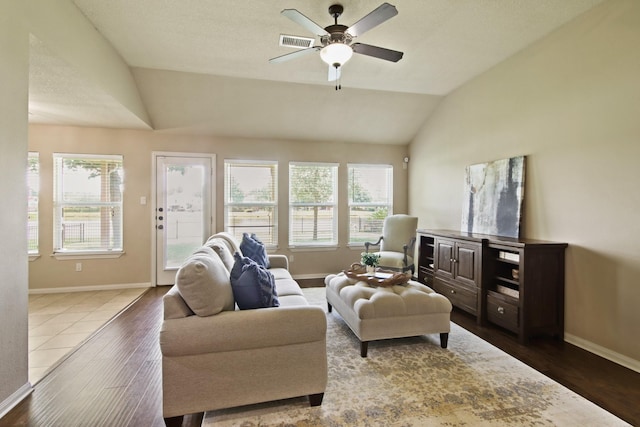 9115 E Lakeside Dr, Magnolia, TX 77354 - living room featuring vaulted ceiling, dark wood-type flooring, healthy amount of natural light, and baseboards