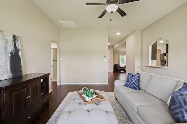 9115 E Lakeside Dr, Magnolia, TX 77354 - living room with arched walkways, dark wood-style flooring, ceiling fan, baseboards, and vaulted ceiling