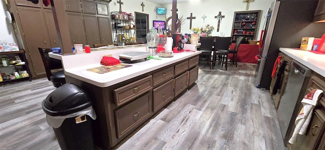 1560 Fm 355, Groveton, TX 75845 - kitchen with light countertops, a center island, light wood-type flooring, and freestanding refrigerator
