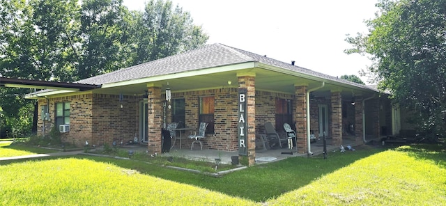 1560 Fm 355, Groveton, TX 75845 - view of home's exterior featuring a lawn, brick siding, and a patio area