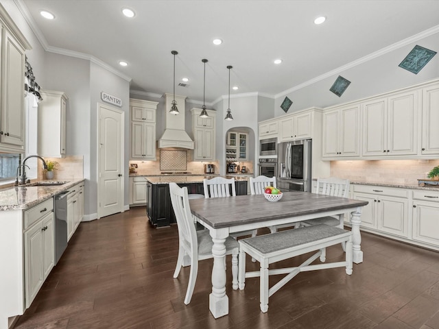 18910 Paddlefish Way, Cypress, TX 77433 - kitchen featuring appliances with stainless steel finishes, backsplash, crown molding, premium range hood, and recessed lighting