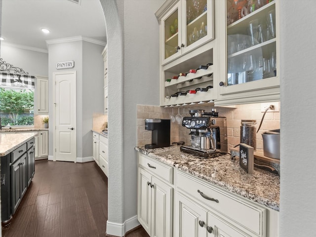 18910 Paddlefish Way, Cypress, TX 77433 - bar featuring crown molding, arched walkways, decorative backsplash, dark wood-style floors, and recessed lighting