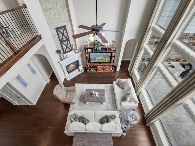 18910 Paddlefish Way, Cypress, TX 77433 - living room featuring a towering ceiling, wood finished floors, healthy amount of natural light, and a glass covered fireplace