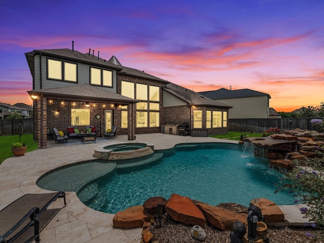 18910 Paddlefish Way, Cypress, TX 77433 - pool at dusk featuring a patio area, a fenced backyard, and a pool with connected hot tub