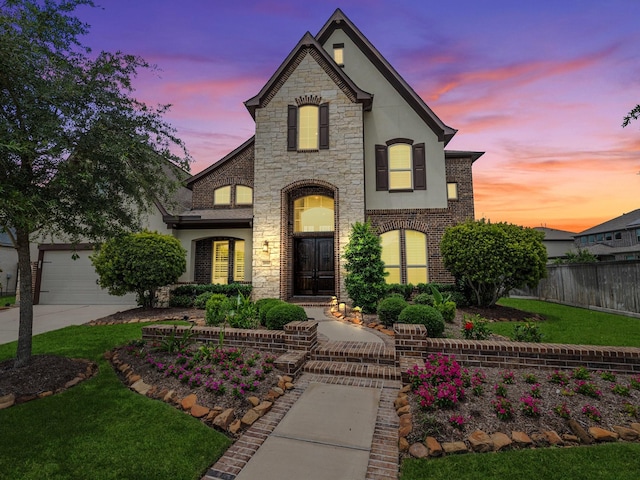18910 Paddlefish Way, Cypress, TX 77433 - french country home featuring stucco siding, stone siding, and driveway
