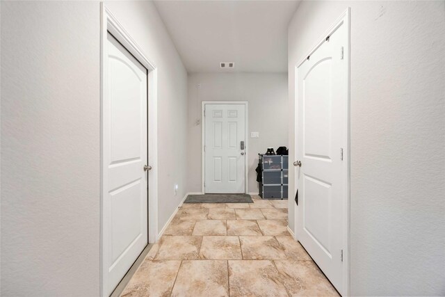 4507 Terrazza Verde Dr, Katy, TX 77493 - hallway featuring light stone finish flooring and baseboards