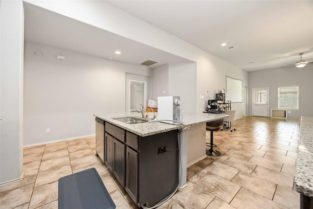 4507 Terrazza Verde Dr, Katy, TX 77493 - kitchen featuring a sink, ceiling fan, an island with sink, stainless steel dishwasher, and light stone countertops