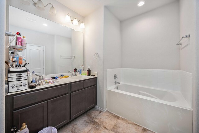 4507 Terrazza Verde Dr, Katy, TX 77493 - bathroom featuring vanity, a garden tub, and baseboards