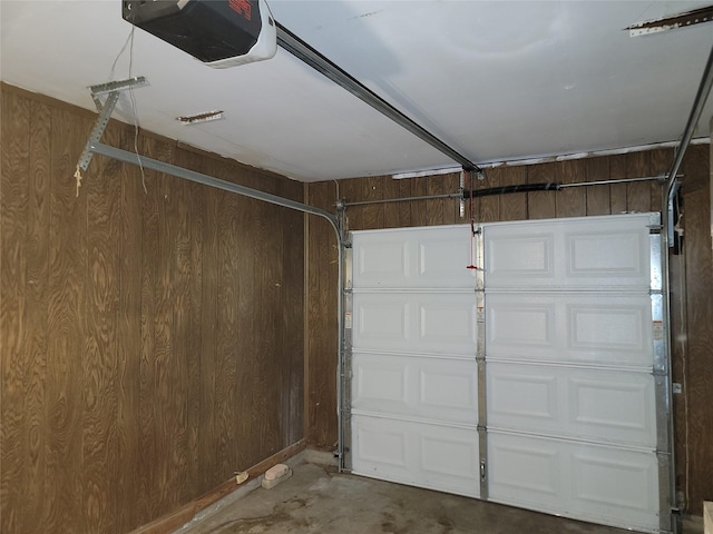7240 Parker Rd, Houston, TX 77016 - garage featuring a garage door opener and wood walls