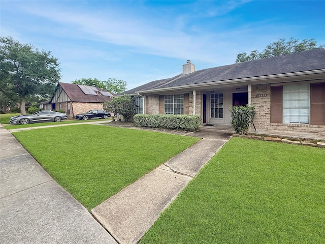 19411 Lazy Valley Dr, Katy, TX 77449 - single story home featuring brick siding, a front yard, a chimney, covered porch, and a shingled roof