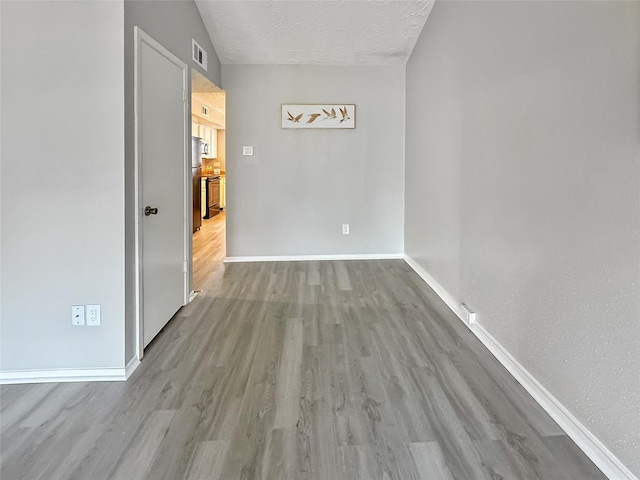 19411 Lazy Valley Dr, Katy, TX 77449 - empty room featuring wood finished floors, baseboards, and a textured ceiling