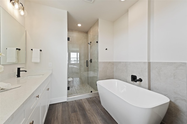 3905 Pinemont Dr Unit G, Houston, TX 77018 - full bathroom with a soaking tub, vanity, a shower stall, wood finished floors, and recessed lighting