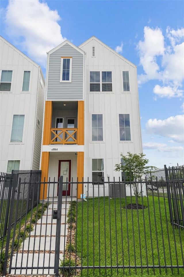 3905 Pinemont Dr Unit G, Houston, TX 77018 - view of front facade featuring board and batten siding and a gate