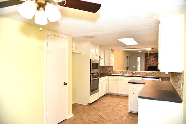 13407 Linden St, Sugar Land, TX 77498 - kitchen with appliances with stainless steel finishes, a sink, dark countertops, tasteful backsplash, and a textured ceiling