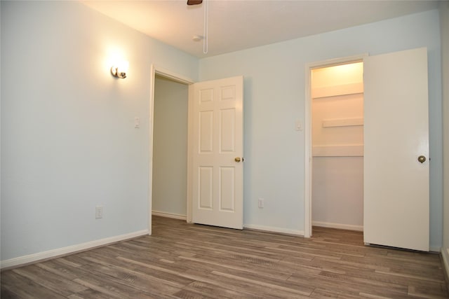 13407 Linden St, Sugar Land, TX 77498 - unfurnished bedroom with wood finished floors, a closet, and baseboards