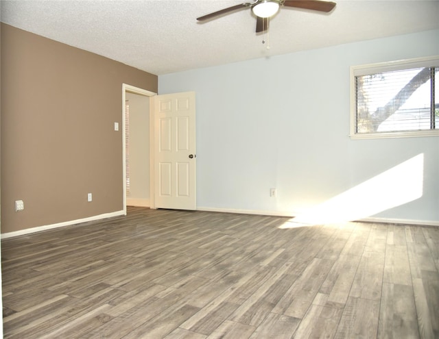13407 Linden St, Sugar Land, TX 77498 - unfurnished room with a ceiling fan, wood finished floors, baseboards, and a textured ceiling