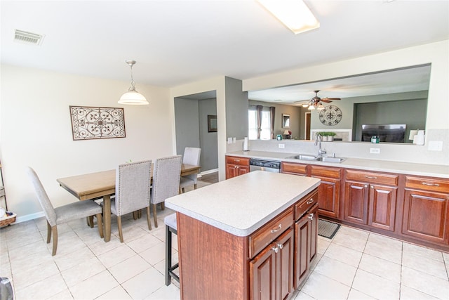 4919 Bentonite Blvd, Baytown, TX 77521 - kitchen featuring a sink, light countertops, light tile patterned floors, and a kitchen island
