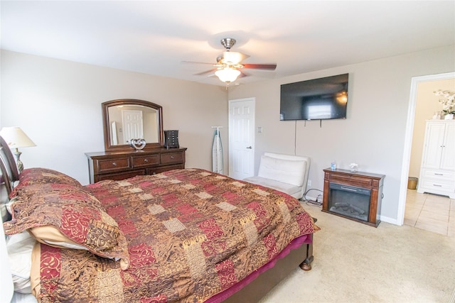 4919 Bentonite Blvd, Baytown, TX 77521 - bedroom with light carpet, a glass covered fireplace, and ceiling fan