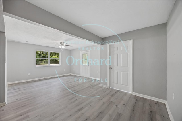 9196 White Oak Dr, Conroe, TX 77384 - empty room featuring baseboards, wood finished floors, and ceiling fan