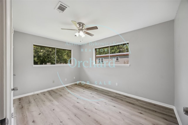 9196 White Oak Dr, Conroe, TX 77384 - spare room with a ceiling fan, wood finished floors, and baseboards