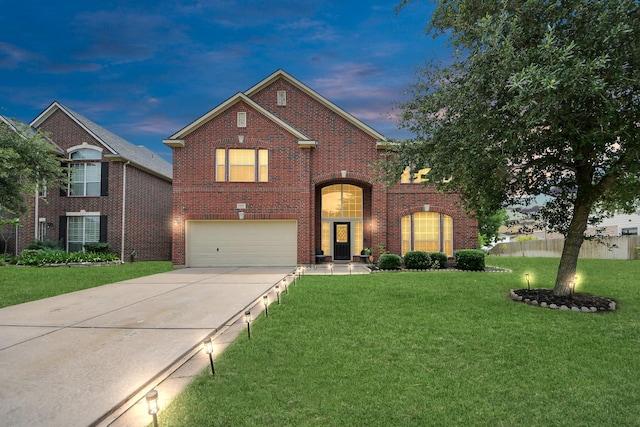 11311 Burmese Ln, Sugar Land, TX 77478 - traditional home with an attached garage, driveway, a front lawn, and brick siding