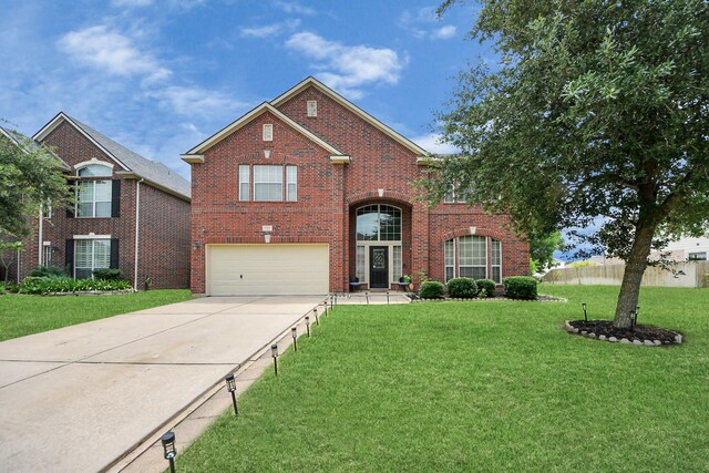 11311 Burmese Ln, Sugar Land, TX 77478 - traditional home featuring a garage, concrete driveway, and brick siding