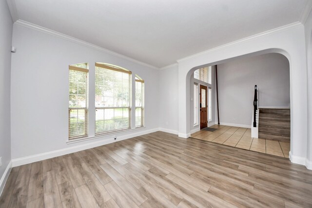 11311 Burmese Ln, Sugar Land, TX 77478 - spare room with arched walkways, crown molding, wood finished floors, baseboards, and stairs