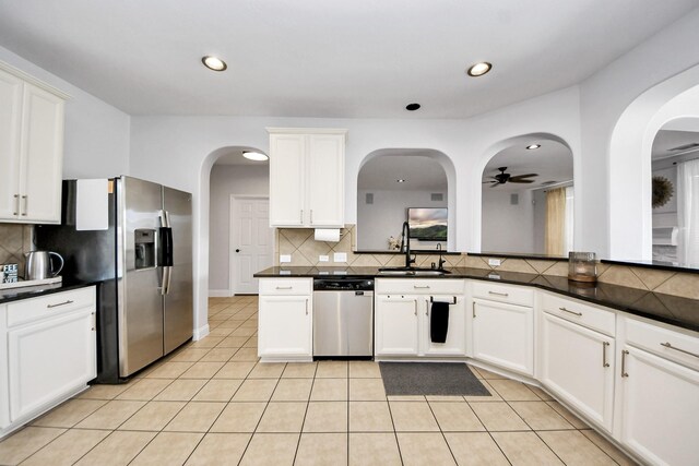 11311 Burmese Ln, Sugar Land, TX 77478 - kitchen featuring stainless steel appliances, a sink, decorative backsplash, dark countertops, and recessed lighting