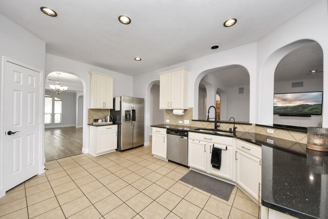 11311 Burmese Ln, Sugar Land, TX 77478 - kitchen featuring appliances with stainless steel finishes, a sink, backsplash, light tile patterned flooring, and recessed lighting